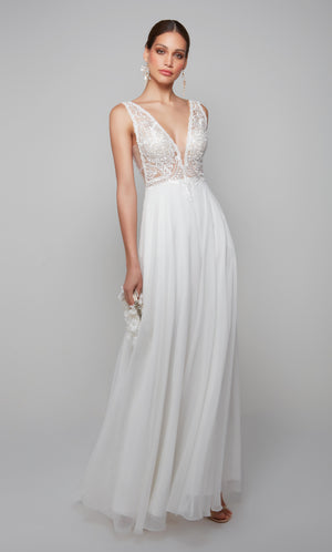 Plunging beach wedding dress with an elegant lace bodice and flowy chiffon skirt in white.