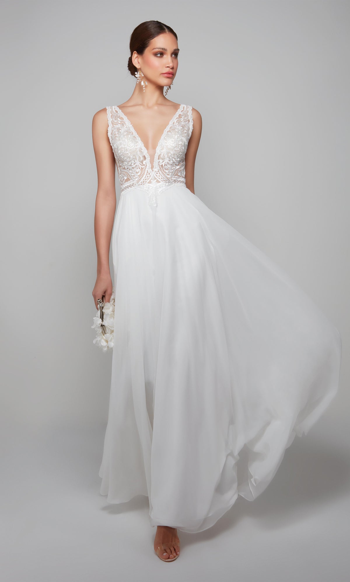 Plunging flowy chiffon wedding dress with an elegant lace bodice in white.