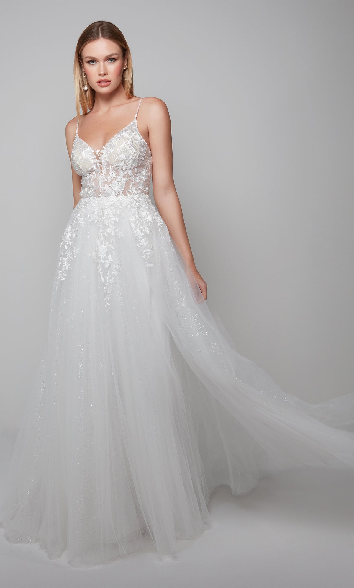 Sleeveless tulle wedding dress with a sheer lace bodice in ivory.