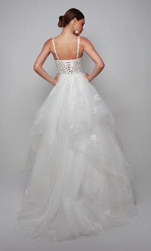 Plunging floral lace applique wedding dress with a sheer lace up back and tiered skirt in ivory.