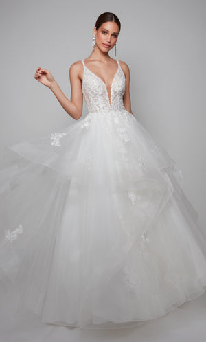 Plunging corset wedding dress with a lace bodice and tiered tulle skirt in ivory.