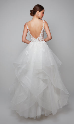 Deep V back wedding dress with a sheer floral lace bodice and tiered skirt with floral lace appliques in ivory.