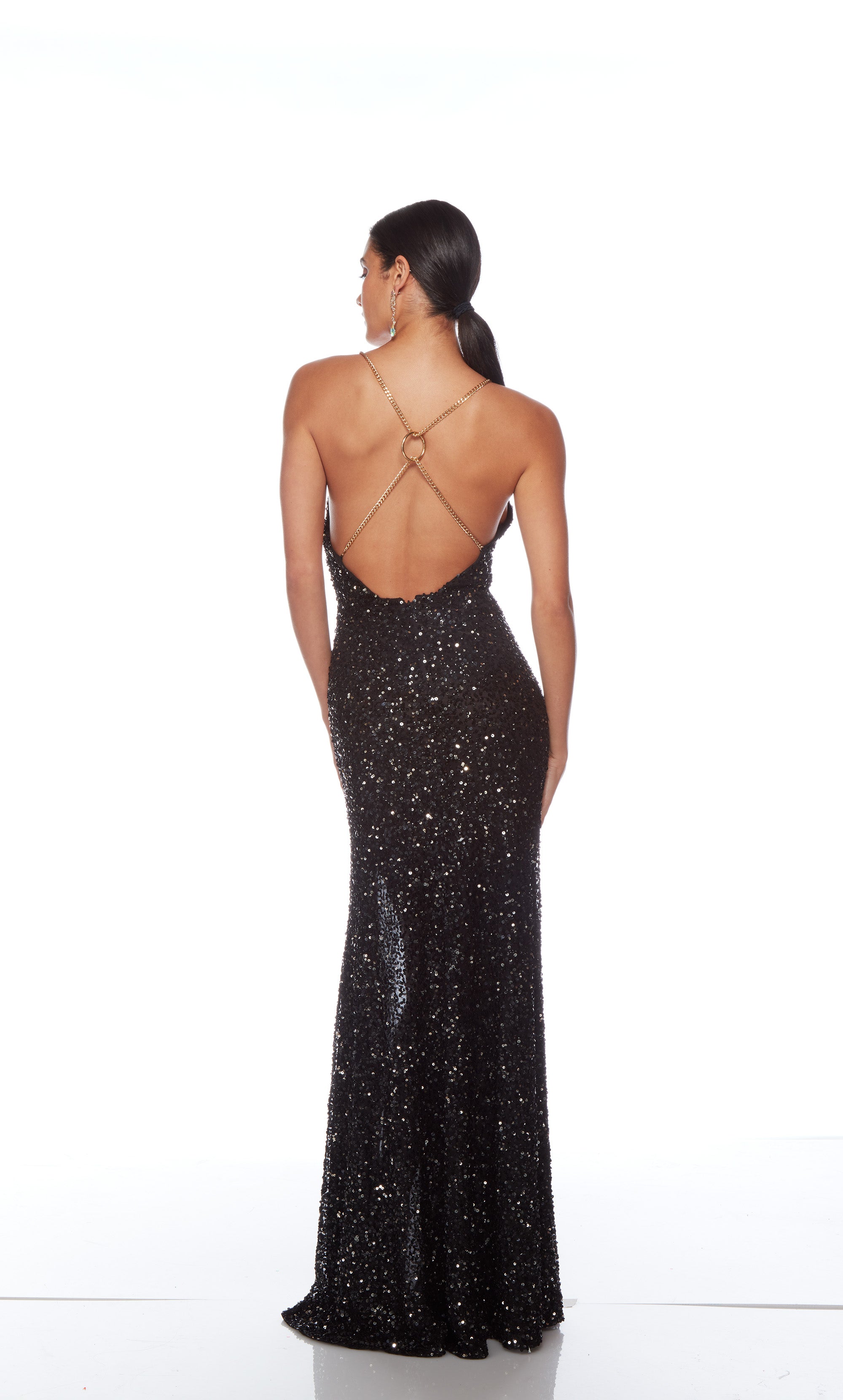 Sophisticated black sequin gown: Plunging neckline, slit, gold chain straps for an edgy and elegant vibe.