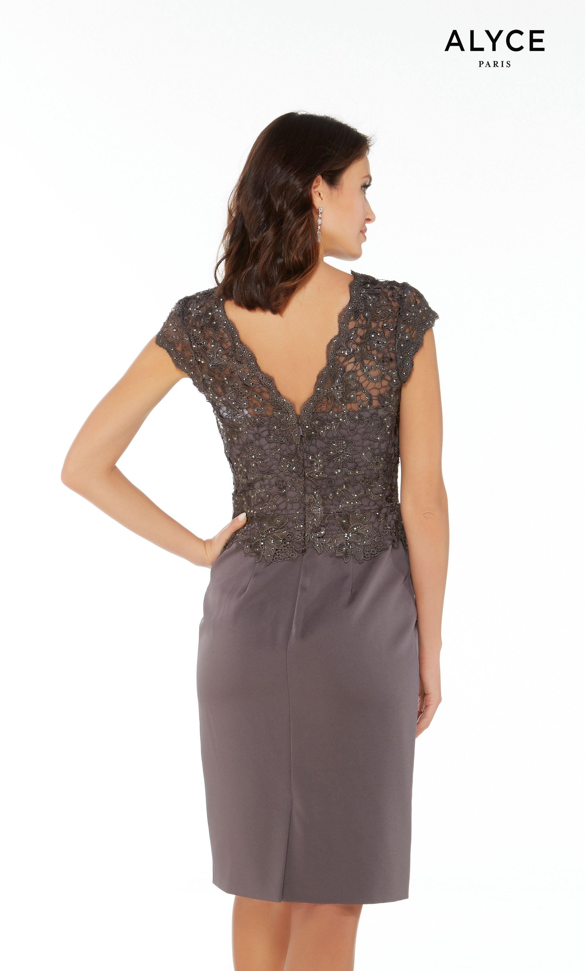 Gunmetal jersey knee length cocktail dress with a V-neck, cap sleeves, and a lace peplum top